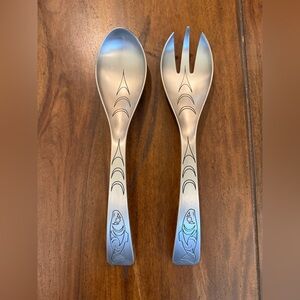 A set of Native Essence pewter salad servers featuring a Salmon Spirit design.